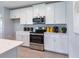 Bright kitchen features white cabinetry, stainless appliances, and modern decor at 1234 Sand Torch Cir, Davenport, FL 33837