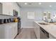Bright kitchen features white cabinetry, stainless appliances, and a long island with sink at 1234 Sand Torch Cir, Davenport, FL 33837