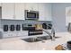 Bright kitchen with white cabinets, stainless steel appliances, and a stylish faucet at 1234 Sand Torch Cir, Davenport, FL 33837