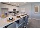 Bright kitchen features white cabinetry, stainless appliances, long island with seating, and modern decor at 1234 Sand Torch Cir, Davenport, FL 33837