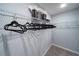 Walk-in closet with wire shelving, clothes hangers, and a place for extra storage on the top shelf at 1234 Sand Torch Cir, Davenport, FL 33837
