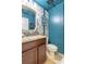 Stylish powder room with a granite-topped vanity and charming floral wallpaper at 12862 Strode Ln, Windermere, FL 34786