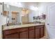 Bathroom featuring a double vanity with granite countertops and tile floors at 12862 Strode Ln, Windermere, FL 34786