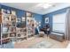 Bright blue bedroom with bookshelves, desk, and a ceiling fan at 12862 Strode Ln, Windermere, FL 34786