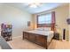 Bright bedroom featuring a large window, ceiling fan, and a cozy bed at 12862 Strode Ln, Windermere, FL 34786