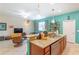 Open-concept kitchen with stainless appliances, granite counters, and views into the living room at 12862 Strode Ln, Windermere, FL 34786