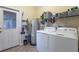 Clean and functional laundry room with modern appliances, tile floor and wire shelving at 12862 Strode Ln, Windermere, FL 34786