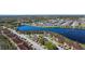Stunning aerial view of lakeside community with lush landscaping, parking, and nearby amenities at 13852 Timberbrooke Dr # 203, Orlando, FL 32824