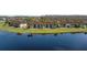 Aerial view of condos with lake and lush green space, nestled in a quiet neighborhood at 13852 Timberbrooke Dr # 203, Orlando, FL 32824