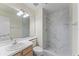 Bathroom featuring a white marble tiled walk-in shower and a modern vanity sink at 13852 Timberbrooke Dr # 203, Orlando, FL 32824