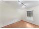 An empty bedroom space with hardwood flooring and a bright window at 13852 Timberbrooke Dr # 203, Orlando, FL 32824