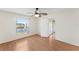 Bright bedroom featuring a ceiling fan, wood floors, and a window with a tranquil water view at 13852 Timberbrooke Dr # 203, Orlando, FL 32824