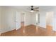 An open view of the primary bedroom with wood floors and access to the bathroom at 13852 Timberbrooke Dr # 203, Orlando, FL 32824