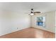 Bright bedroom with hardwood floors, fan, and a window with peaceful water views at 13852 Timberbrooke Dr # 203, Orlando, FL 32824