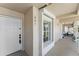 Inviting condo entrance featuring a secure door, window, and covered porch area at 13852 Timberbrooke Dr # 203, Orlando, FL 32824