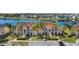 Scenic aerial view of condos by the lake, featuring mature landscaping and ample parking at 13852 Timberbrooke Dr # 203, Orlando, FL 32824