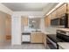 Functional kitchen with stainless steel appliances and open view of adjacent living area at 13852 Timberbrooke Dr # 203, Orlando, FL 32824