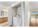 Convenient in-unit laundry closet with washer and dryer next to the bathroom at 13852 Timberbrooke Dr # 203, Orlando, FL 32824