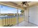Relaxing screened-in patio featuring a ceiling fan and a serene view of the tranquil lake at 13852 Timberbrooke Dr # 203, Orlando, FL 32824