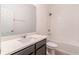 Well-lit bathroom features a modern vanity, large mirror, and a shower-over-tub design at 14007 Picard Aly, Winter Garden, FL 34787