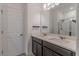 Bathroom features dual sinks with grey cabinets, a large mirror, and walk-in shower at 14007 Picard Aly, Winter Garden, FL 34787