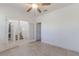 A bedroom with an ensuite bathroom and staircase visible through glass doors at 14007 Picard Aly, Winter Garden, FL 34787