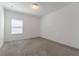 An empty bedroom features neutral carpet and one window at 14007 Picard Aly, Winter Garden, FL 34787