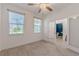 Bright bedroom with tile flooring and lots of natural light. Ensuite bathroom shown at 14007 Picard Aly, Winter Garden, FL 34787