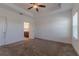 Empty bedroom features neutral carpeting, white walls, a ceiling fan and access to the bathroom at 14007 Picard Aly, Winter Garden, FL 34787