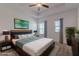 Staged bedroom features a tray ceiling, ceiling fan, and a large bed with nightstands at 14007 Picard Aly, Winter Garden, FL 34787
