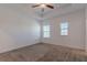 An empty bedroom has neutral carpeting, two windows, and white walls at 14007 Picard Aly, Winter Garden, FL 34787