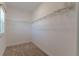 Walk-in closet offers shelving, neutral carpet, and a window for natural light at 14007 Picard Aly, Winter Garden, FL 34787