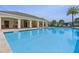 Serene community pool with a covered seating area, perfect for relaxing and enjoying the Florida sunshine at 14007 Picard Aly, Winter Garden, FL 34787