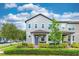 Charming two-story home featuring a well-manicured front yard with vibrant landscaping at 14007 Picard Aly, Winter Garden, FL 34787