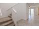Hallway and staircase featuring modern tile flooring and carpeted stairs at 14007 Picard Aly, Winter Garden, FL 34787