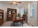 Stylish home office featuring a wood desk, shelving, and a comfortable leather chair at 14007 Picard Aly, Winter Garden, FL 34787