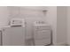 Efficient laundry area features a washer, dryer, and overhead wire rack for storage at 14007 Picard Aly, Winter Garden, FL 34787
