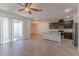 Open-concept living room with a view of the kitchen and a sliding door to the patio at 14007 Picard Aly, Winter Garden, FL 34787