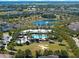 Aerial view of community pool, clubhouse, walking paths, and a scenic lake with a fountain at 14172 Hutchinson St, Winter Garden, FL 34787