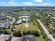 An aerial view of a community pool, clubhouse, and a lake amidst residential homes and green spaces at 14172 Hutchinson St, Winter Garden, FL 34787