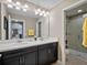 Bathroom with double sink vanity, modern lighting, and glass shower at 14172 Hutchinson St, Winter Garden, FL 34787