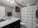 Bathroom featuring a single sink vanity, and shower with skyline curtain at 14172 Hutchinson St, Winter Garden, FL 34787