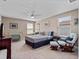 Comfortable bedroom featuring plush carpet, ceiling fan, and a cozy rocking chair at 14172 Hutchinson St, Winter Garden, FL 34787