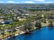Aerial view of a residential community featuring a pool, lake access, and lush landscaping at 14172 Hutchinson St, Winter Garden, FL 34787