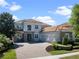 Beautiful two-story home featuring a brick driveway and tile roof, providing a luxurious curb appeal at 14172 Hutchinson St, Winter Garden, FL 34787