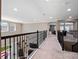 Upstairs hallway features neutral carpet, dark railings, and recessed lighting at 14172 Hutchinson St, Winter Garden, FL 34787