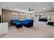 Spacious living room with plush carpeting, ceiling fan, and bright windows at 14172 Hutchinson St, Winter Garden, FL 34787