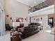 Large living room features a balcony and modern decor, with a staircase to the side at 14172 Hutchinson St, Winter Garden, FL 34787