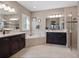 Spacious main bathroom with double vanities, a soaking tub, and a separate shower at 14172 Hutchinson St, Winter Garden, FL 34787