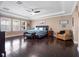 Spacious main bedroom with a tray ceiling, dark wood floors, and large windows at 14172 Hutchinson St, Winter Garden, FL 34787